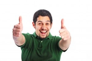 Excited man in green shirt giving two thumbs up