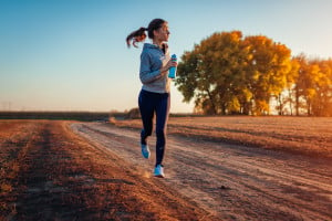 Woman jogging on country road