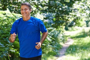 Older man jogging on country path